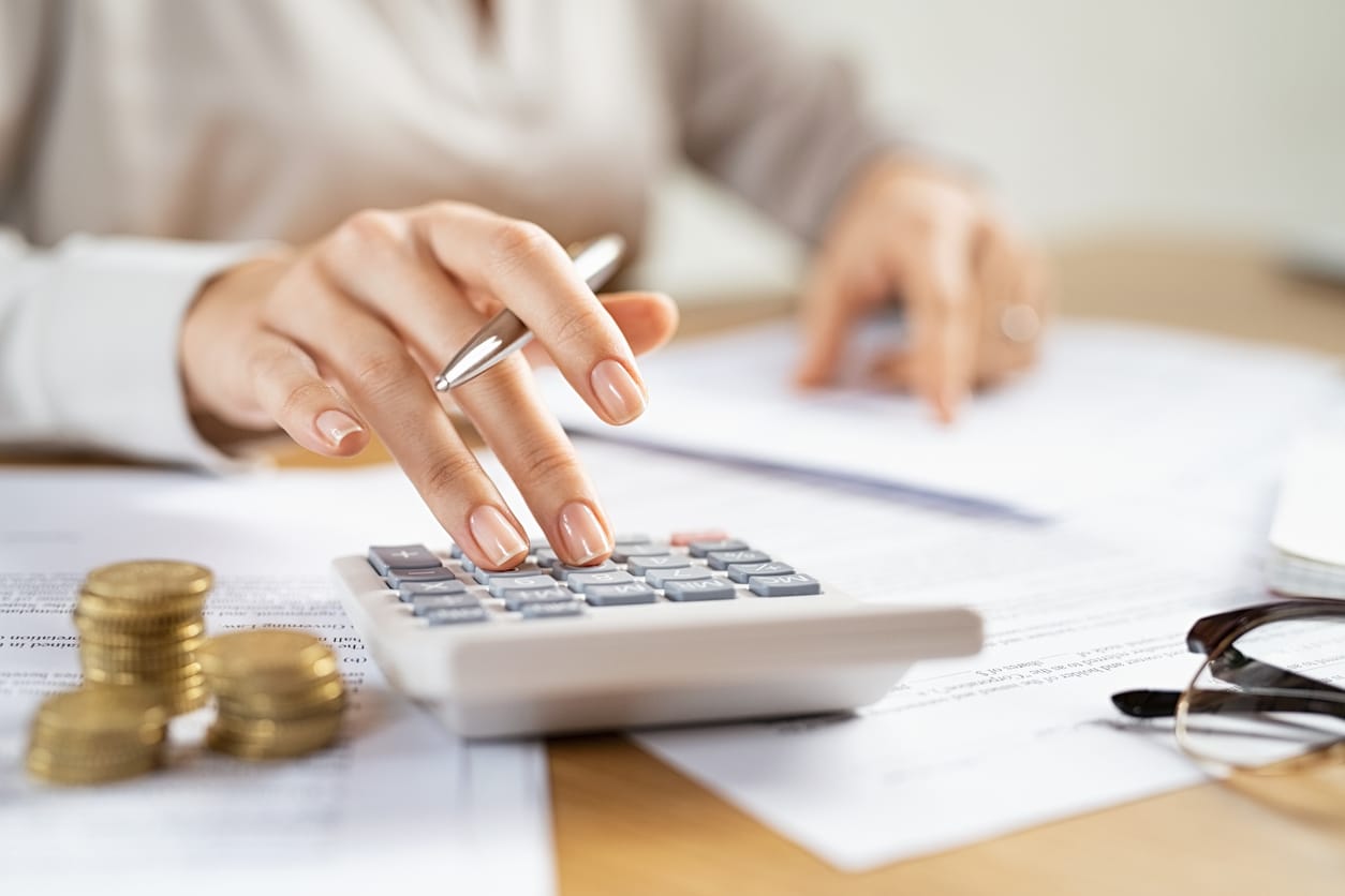 Business Woman Using Calculator To Manage Finance