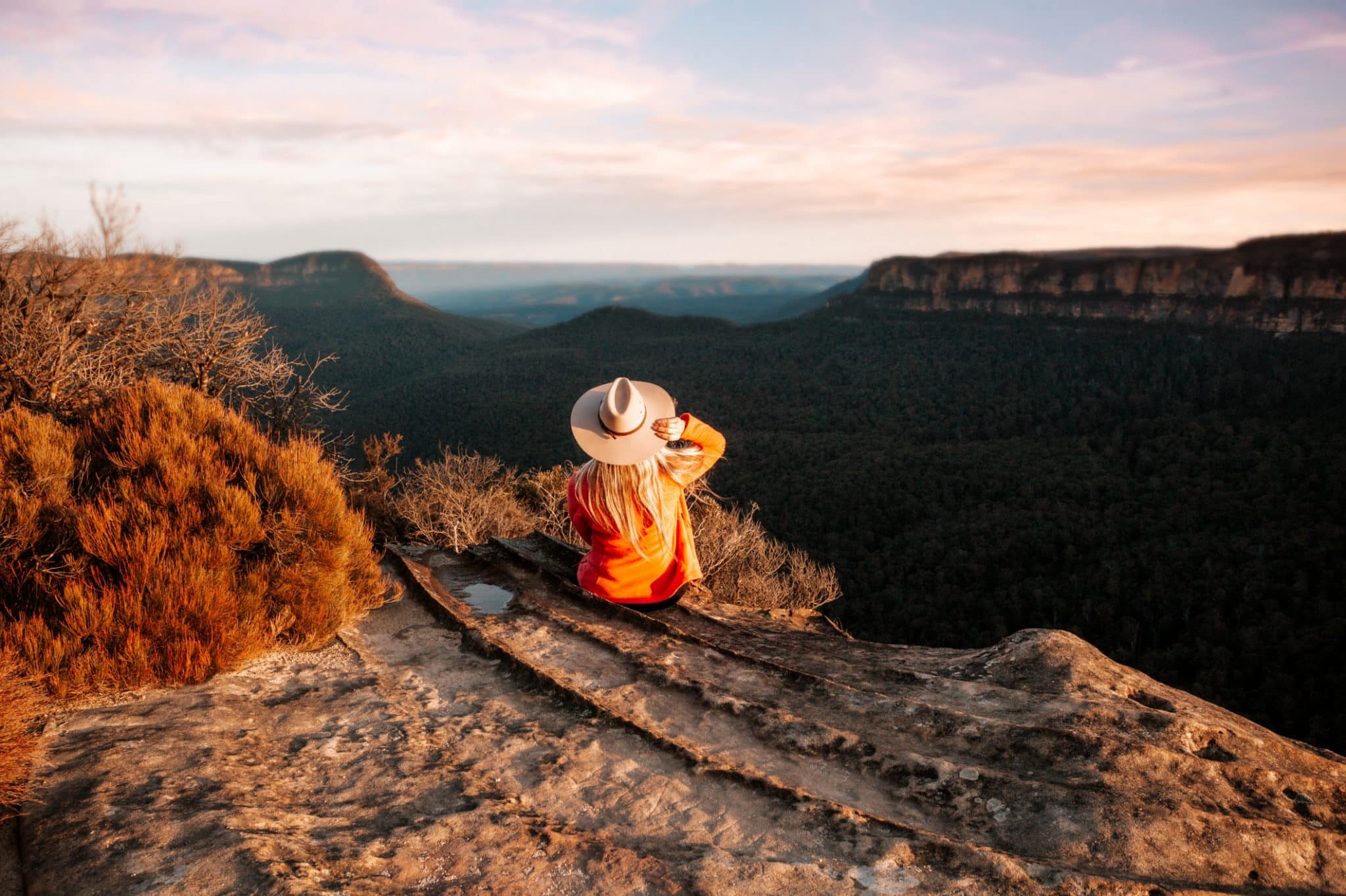 Woman Looks Out Over The Mountains In The Late Afternoon Sun