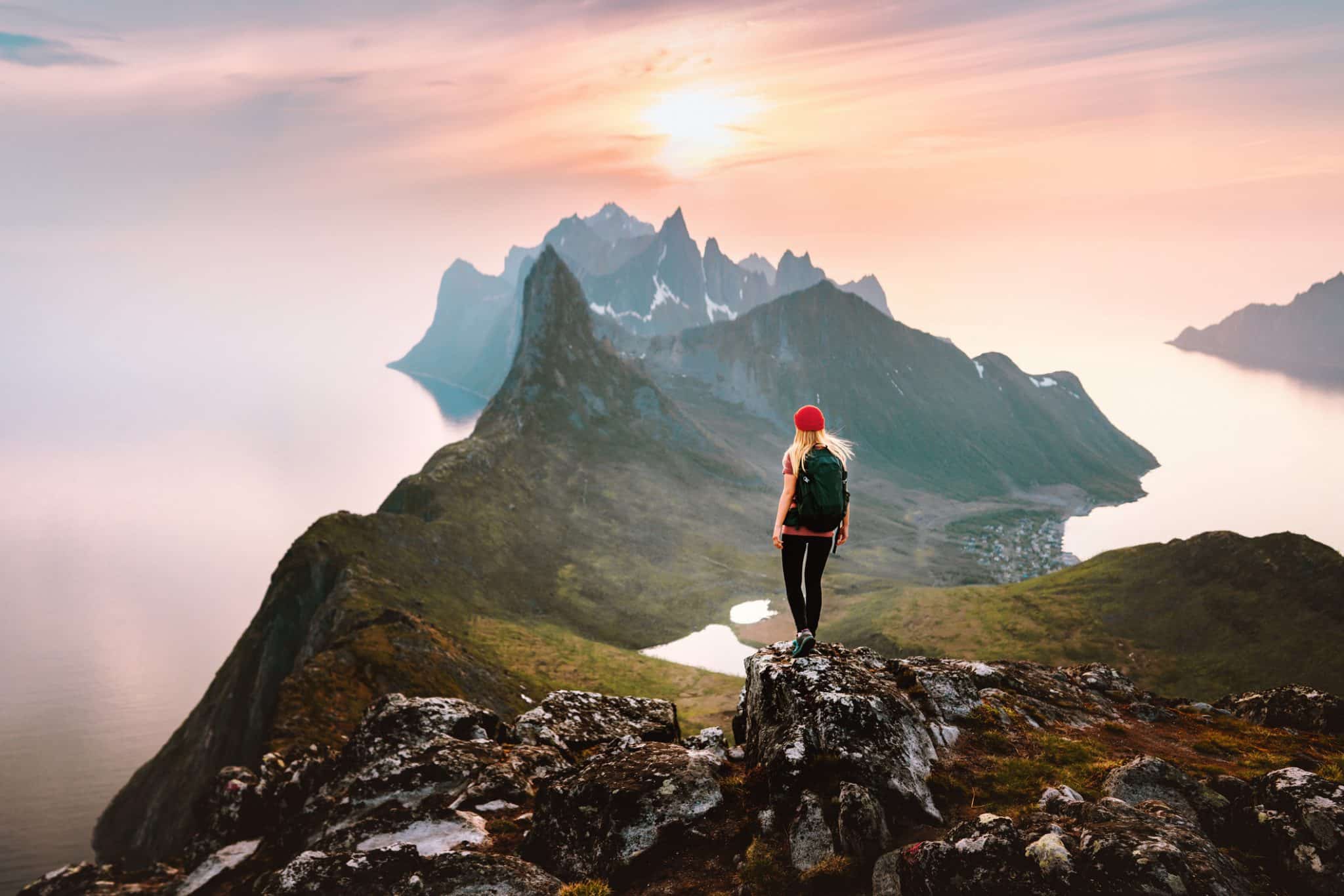 Traveler Woman Hiking Solo In Mountains Of Norway Outdoor Activity Travel Summer Vacations Healthy Lifestyle Girl Tourist Enjoying Sunset View On Summit Exploring Senja Island