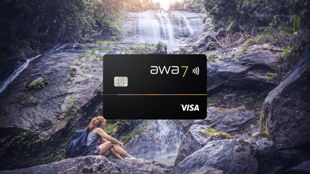 awa7 credit card in the foreground, in the background a hiker at a waterfall