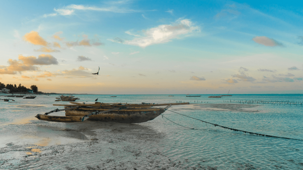 Traditionelle Holzboote am Strand von Sansibar bei Ebbe bei der Abenddämmerung